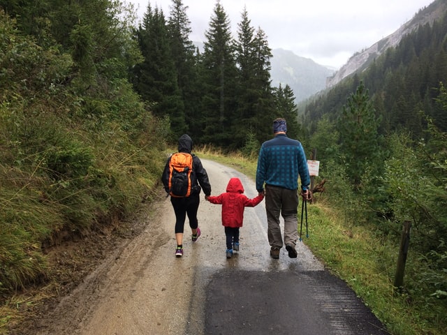 photo of a family walking in the mountains