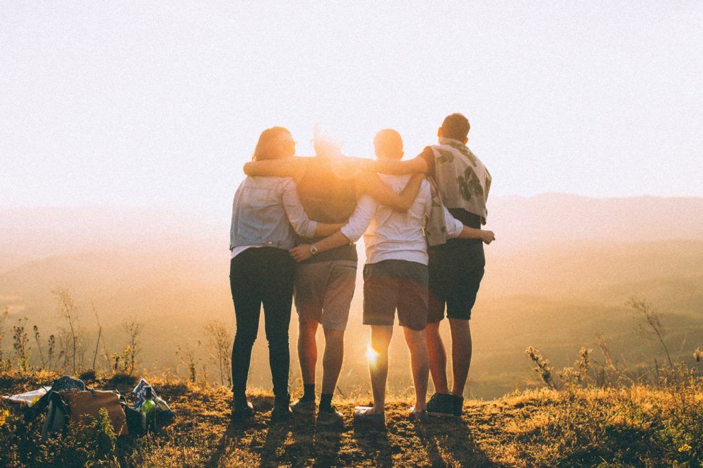 photo of family embracing on mountain